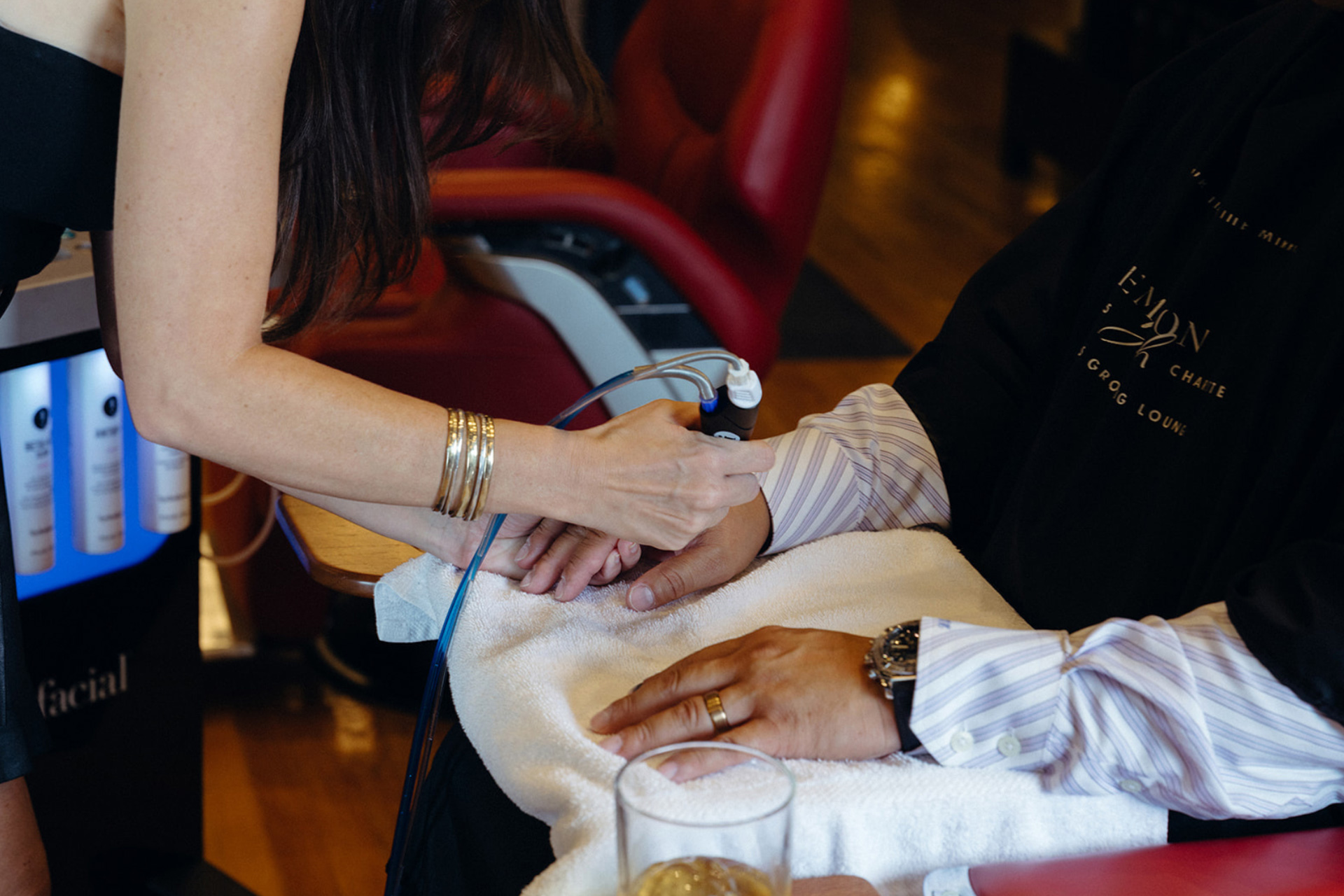 A male client getting professional hand treatment using Hydrafacial at Emerson Joseph in Uptown Charlotte