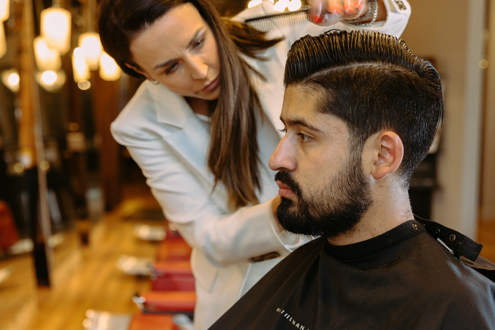 A man gets a haircut at Emerson Joseph